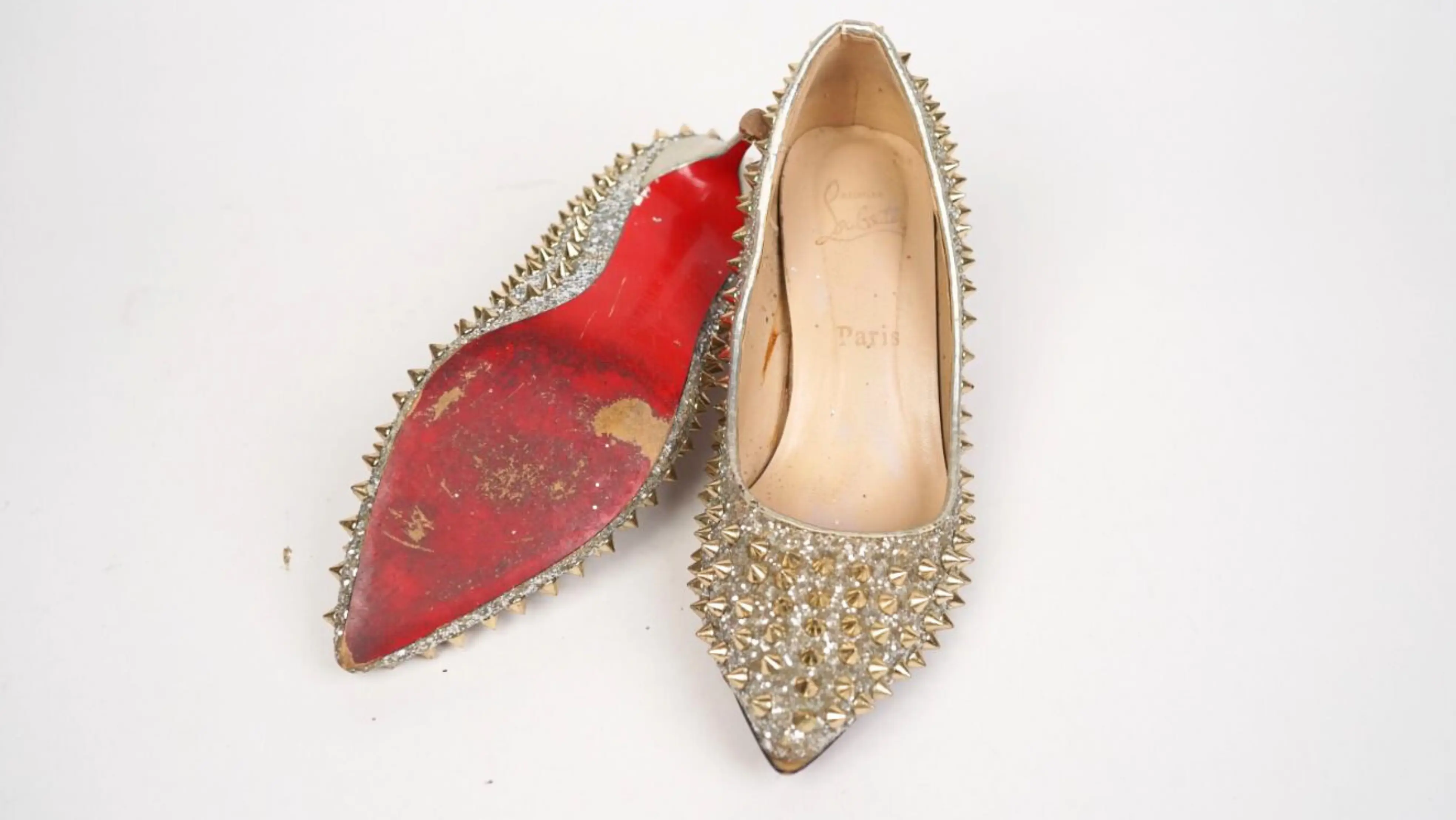 After Louboutin footwear repair and colour restoration with polished, renewed finish