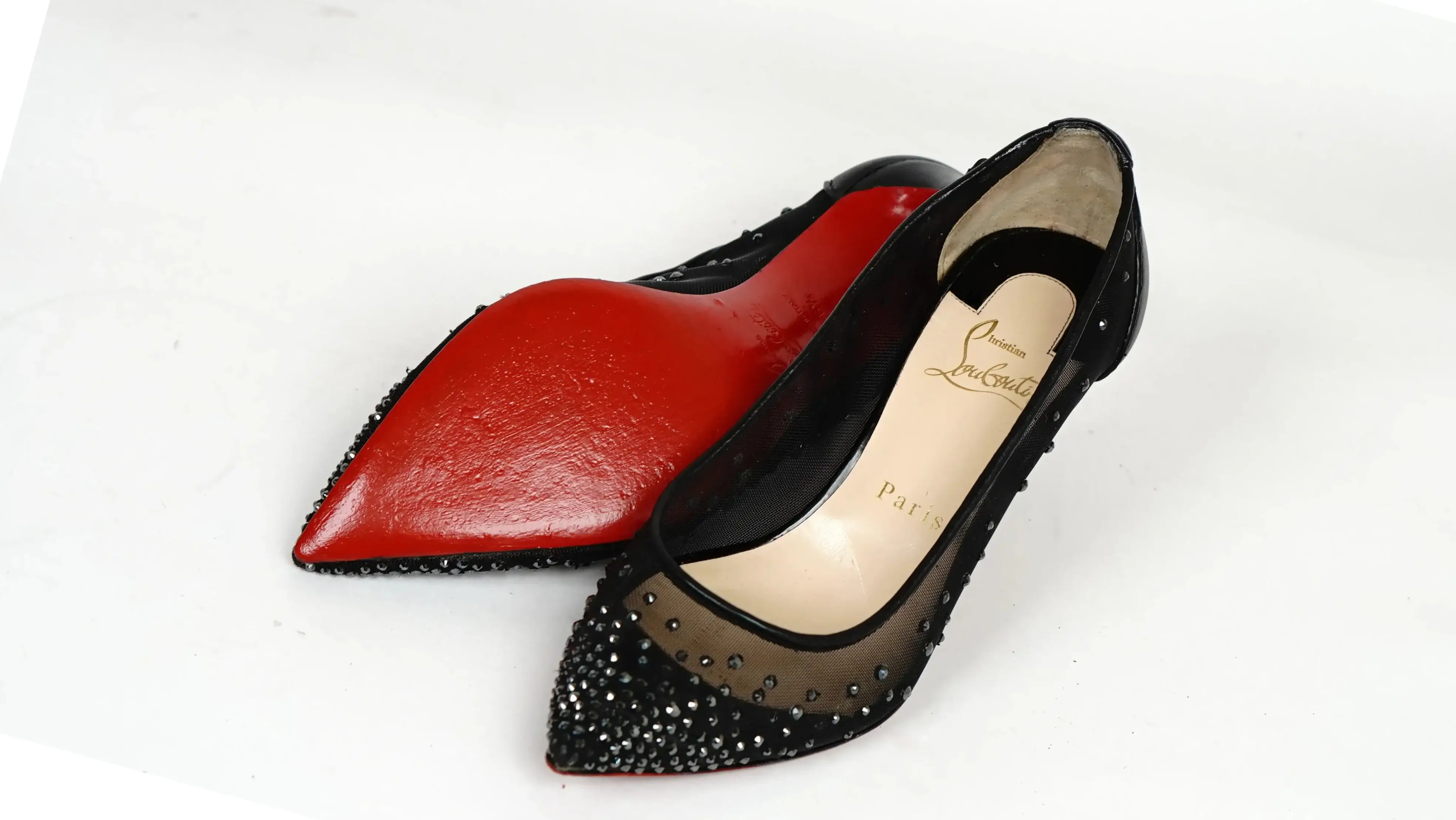 Before Christian Louboutin sole repair worn red outsole
