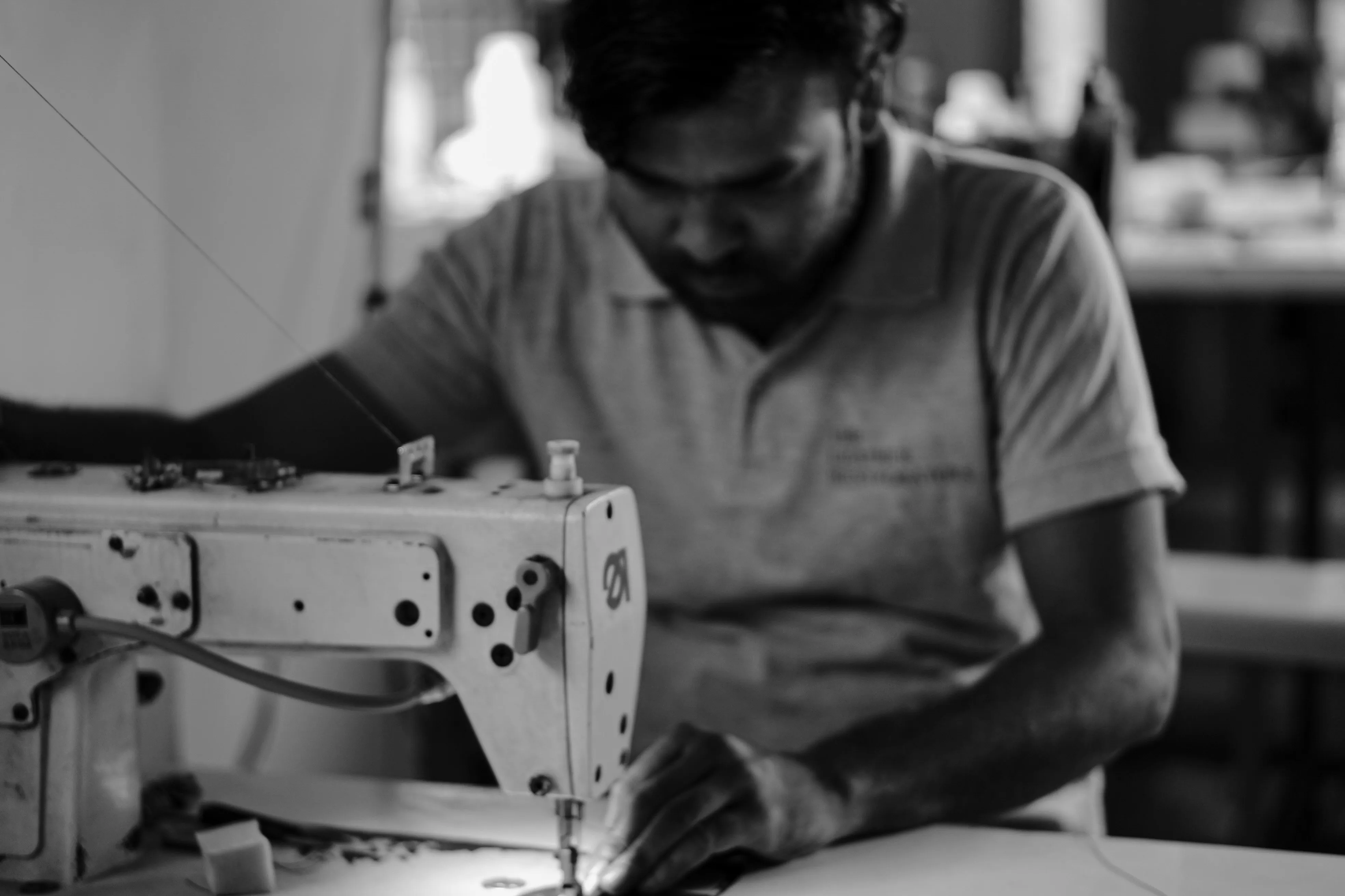 Artisan restoring a Hermès and Saint Laurent leather jacket at The Leather Restorators atelier in Mumbai